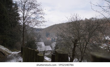 A Small Village With A Railway Bridge In The Background.