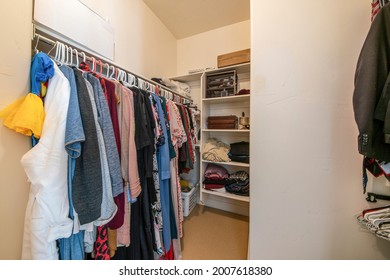 Small Walk In Closet With Clothing Rod And Shelves