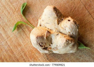 small walnuts bread in  the  shape of a butterfly wings on an old cutter board