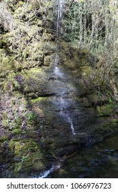 Small Water Fall Going Over The Edge Of A Rock Face