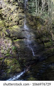 Small Water Fall Going Over The Edge Of A Rock Face