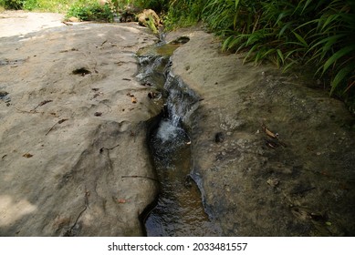 Small Water Stream Among Rocky Forest Area