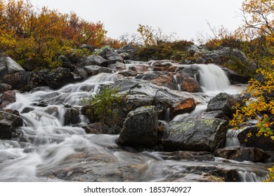 A Small Waterfall In Autumn, In The Murmansk Region On The Middle Peninsula, In Cloudy Weather