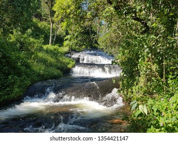 SMALL WATERFALL BETWEEN TREES