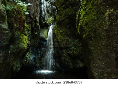 Small waterfall on moss covered black rocks, Adrspach rocks, Czech Republic - Powered by Shutterstock