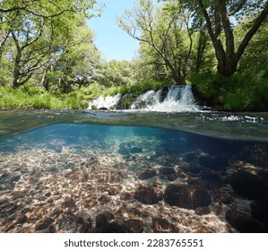 Small waterfall on a river, over and under water surface, split level view, Spain, Galicia, Rio Verdugo - Shutterstock ID 2283765551