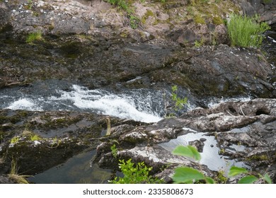 a small waterfall over a rocky cliff