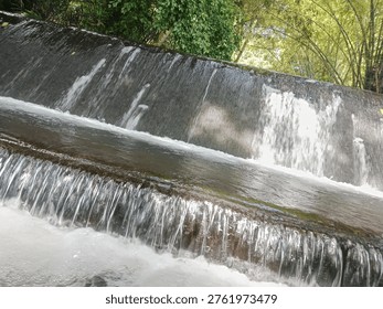A small waterfall or rapids in a river. 