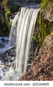 A small waterfall in the rays of the sun