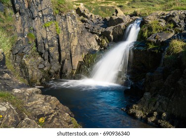 Small waterfall in river falling towards the sea at Welcome Mouth in North Devon