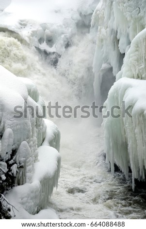 Small waterfall from river flowing between narrow banks in late Winter, Dorwin Falls, Rawdon, Quebec, Canada