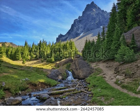 Small Waterfall and Stream Flowing at the Base of the Spire-like Mount Thielsen Peak Along the Pacific Crest Trail