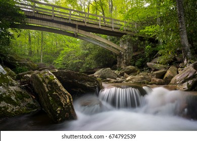 Small waterfall under a hiking trail bridge in the blue ridge mountains of north carolina.