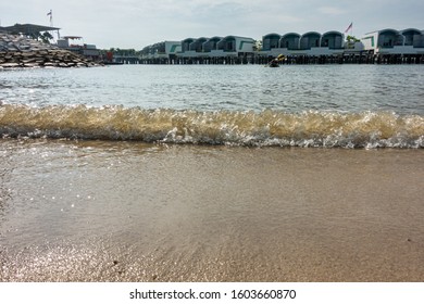 Small waves breaking on sandy beach
