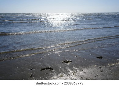 Small waves lapping up on a sandy beach