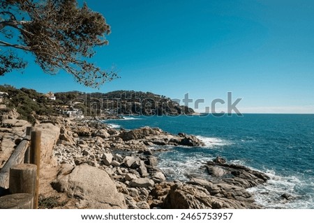 Small waves on cliff rocks in quiet Mediterranean waters seascape coastal landscape in Costa Brava, Catalonia, Mediterranean Sea