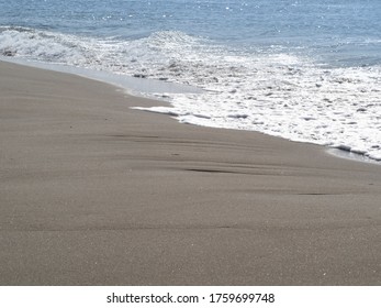 Small waves on the sandy beach in japan.