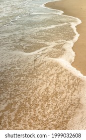 Small waves on sandy beach on Atlantic ocean coast in a sunny summer day