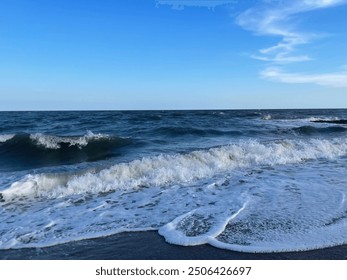 Small waves rolling onto the beach shore in Edisto Island, SC, USA