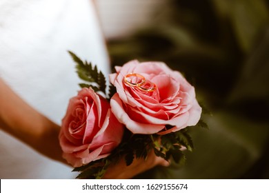 Small Wedding Bouquet Of Pink Roses With Wedding Rings On The Top. Wedding Day Concept.