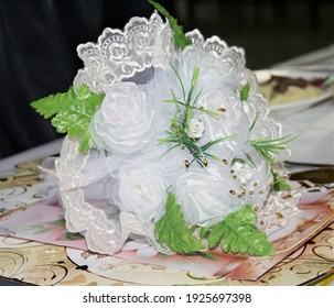 A Small Wedding Bouquet Of White Roses For The Bride Lies On Greeting Cards.