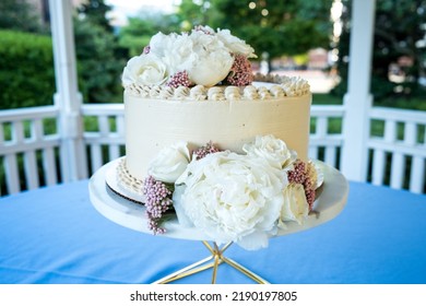 Small Wedding Cake On A Table Under A Gazebo