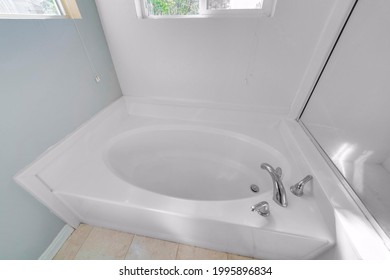 A small white bath in a bathroom - Shutterstock ID 1995896834