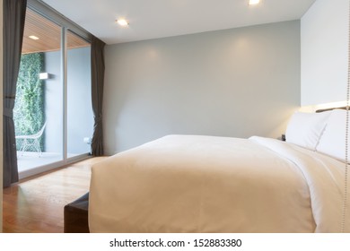 Small White Bedroom In Apartment.