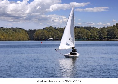 Small White Boat Sailing On The Lake 