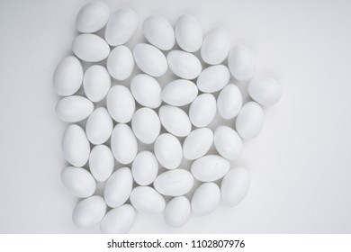 Small white candy on a white background