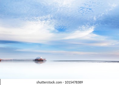 Small White Canopy Building At Sea With Blue Skies