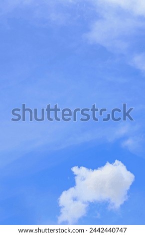 SMALL WHITE CLOUD IN A BLUE SKY WITH FLEECY CLOUD FILM