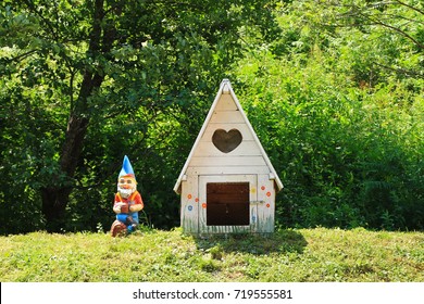 Small White Dog House And A Colorful Dwarf