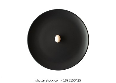 Small White Egg On Black Plate On Isolated White Background