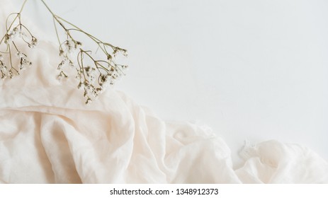 Small white flowers on a soft pink textile