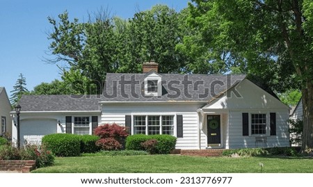 Small White House with One Dormer and Black Shutters