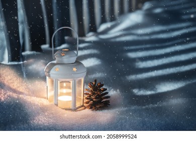 Small White Lantern And Pine Cone In The Snow Garden 