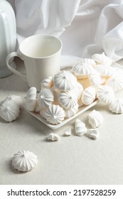 Small White Meringues In A White Dish On The Table.