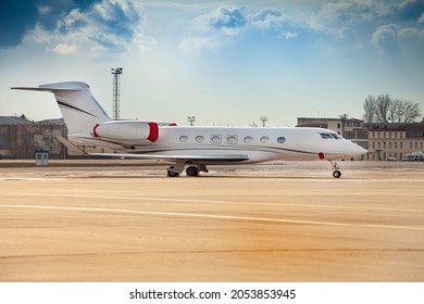 Small White Plane At The Airport. Runway. Charter Flight. Flight On A Journey. Fly In A Private Jet. New Beautiful Modern Transport. Arrival