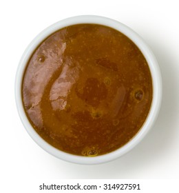 Small White Pot Of Curry Sauce Dip, From Above Isolated On White.