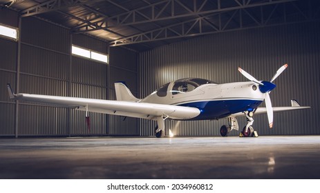 Small White Private Jet Parked In The Hangar