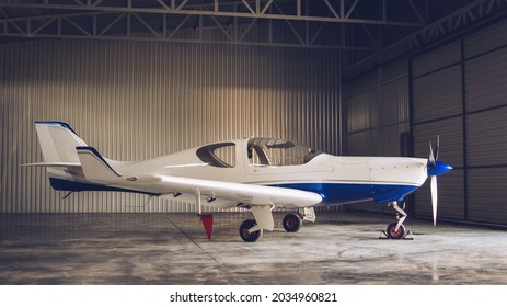 Small White Private Jet Parked In The Hangar
