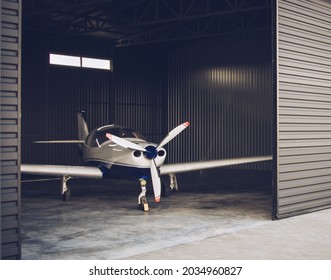 Small White Private Jet Parked In The Hangar