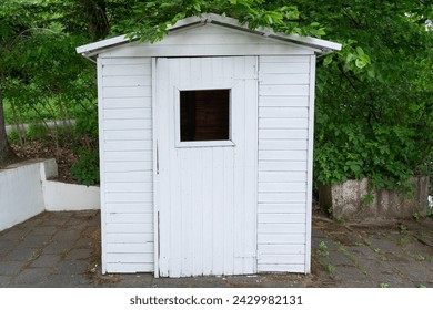 Small white shed in the park - Powered by Shutterstock