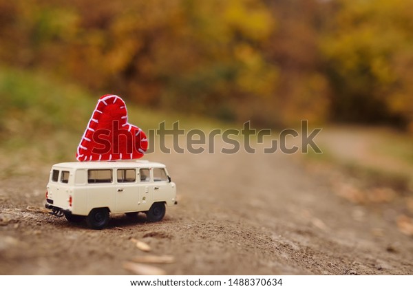 red toy car with yellow roof