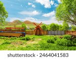 Small windmill on a village site in the mountains of the Trans-Ili Alatau ridge. Countryside and nature of Central Asia. Almaty district, Kazakhstan – May 5, 2024