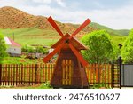 Small windmill on a village site in the mountains of the Trans-Ili Alatau ridge. Countryside and nature of Central Asia. Almaty district, Kazakhstan – May 5, 2024