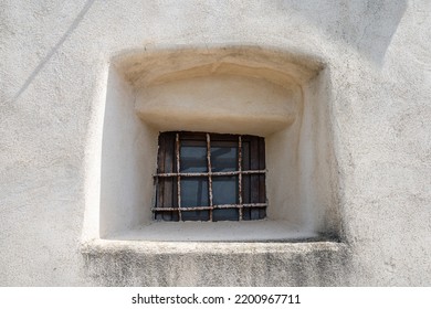 Small window set in an ancient wall.