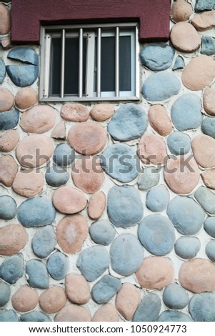 A small window.  stone wall background. Rough Wall Texture.