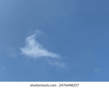 A small, wispy cloud in a clear blue sky, evoking a sense of tranquility and openness. Perfect for backgrounds, nature themes, and peaceful outdoor scenes.